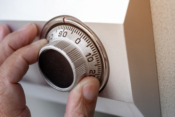 Close-up of hand searching security code of safe