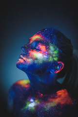 Portrait of a girl painted in fluorescent UV colors.