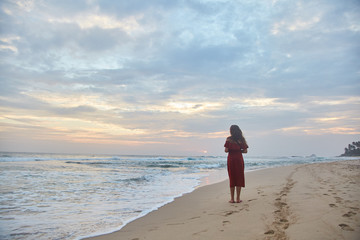 Young girl walking along the beach.