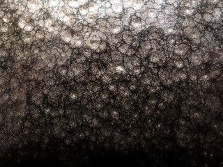 Dark grey textile material, wallpaper with irregular pattern