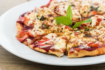 Strawberry pizza on a white plate