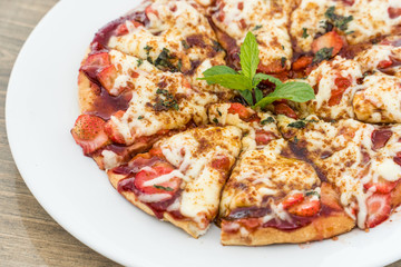 Strawberry pizza on a white plate