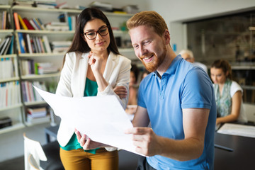 Group of business people working and communicating in office together with colleagues