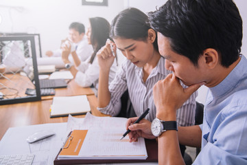 Fototapeta premium Business meetings of real estate brokers and engineering team to review blueprint to build a housing estate at office