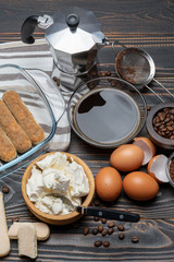 Ingredients for making traditional italian cake tiramisu on wooden table