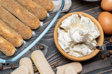 Ingredients for making traditional italian cake tiramisu on wooden table