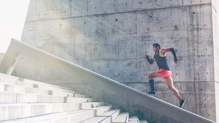 Muscular hispanic Young man training working out outdoors.Concret background wall with copy space area for text message or advertising content.Sunlights, flare effects