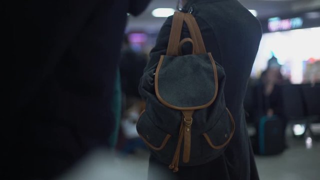 Carefree commuter on railway station waiting train, risk of pickpocketing, crime