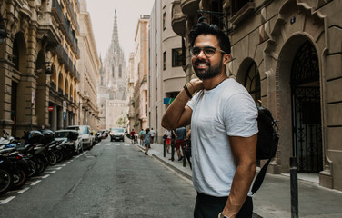 Fototapeta na wymiar Traveler male discover a big europe city, travel and active lifestyle concept.Bearded Tourist Man with black leather bag enjoy beautiful city travel