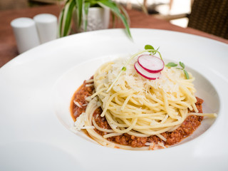 Spaghetti bolognese (spaghetti alla bolognese or spaghetti) a pasta dish consisting of spaghetti served with a sauce made from tomatoes, minced beef, garlic, wine and herbs.