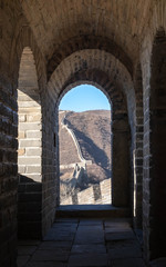 The great wall along the mountain, view from window of the fortress. The China’s famous landmark buildings.