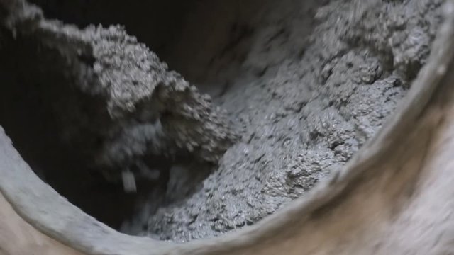 Detail of a concrete mixer working in slow motion
