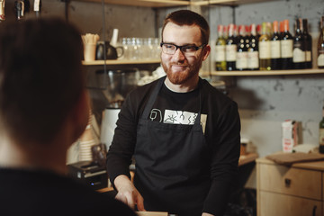 Barista working at the bar with tablet PC