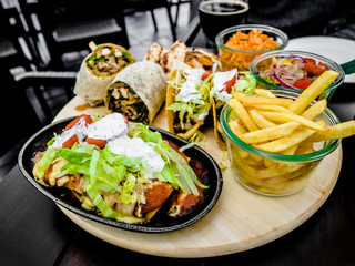 Mexican Chicken Wrap with salad and potato chips, food set, Mexican restaurant in town
