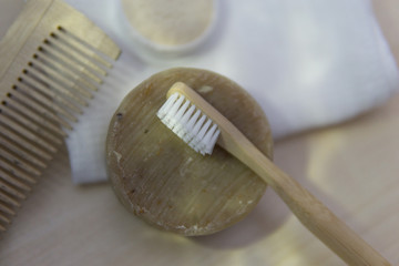 natural oral care in a cozy bathroom in a beautiful morning with a bamboo toothbrush and natural bath accessories