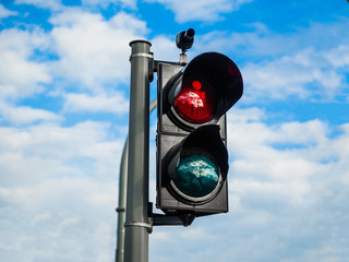 Traffic light signal red and green on a street, road with blue nice sky in city.