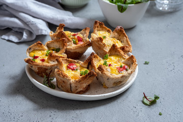 Egg muffins with peppers in a toast cup for breakfast brunch.