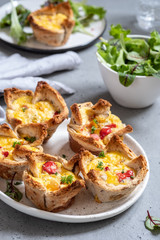 Egg muffins with peppers in a toast cup for breakfast brunch.