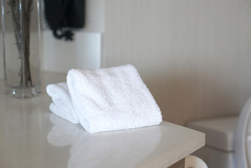 Obraz na płótnie Canvas Folded white clean towels in hotel bathroom