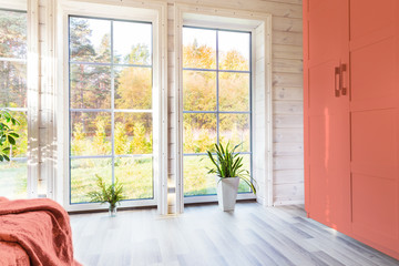 Bright interior, room in wooden house with large window. Scandinavian style. color of the year 2019...