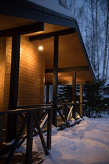 A beautiful architectured modern house in winter forest. Side view