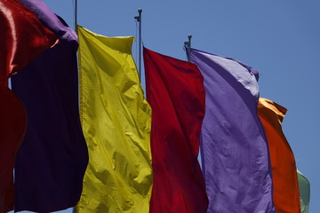 multicolor plain flags on blue sky background