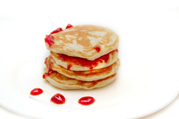 Pancakes with strawberry jam white plate