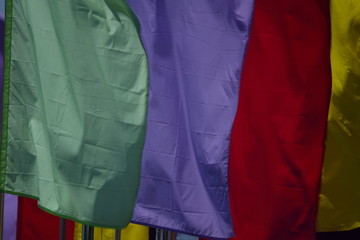 multicolor plain flags on blue sky background