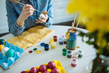 Girl paints eggs