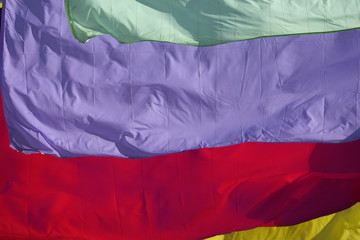 multicolor plain flags on blue sky background