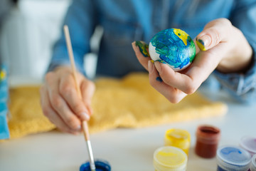 Girl paints eggs