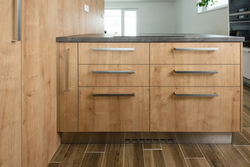 Wooden cabinet with drawers in modern kitchen