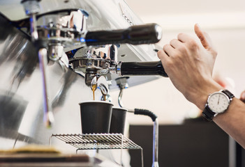 Barista preparing coffee in a cafe. Professional coffee making, service and catering concept