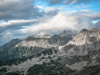 Tatra Mountain part of Carpathian mountain chain in eastern Europe create natural border between Slovakia, Poland. Both protected as national parkland popular destination for winter, summer sports. 