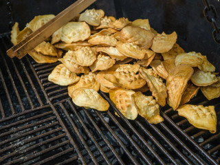 Traditional Polish smoked cheese known as 'oscypek' on barbecue, Oscypek smoked sheep cheese on a grill.