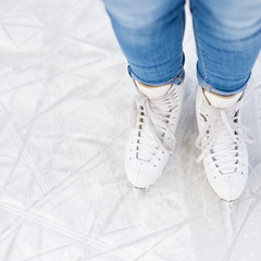 top view of legs in skates over ice