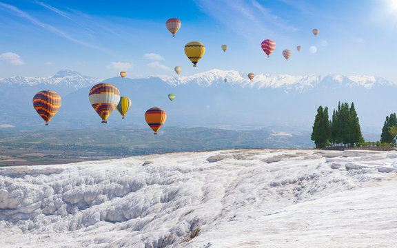 Collage with hot air ballons flying above snowy white Pamukkale in Turkey
