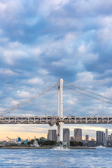 Ship sailing in Odaiba Bay under the Rainbow Bridge of Odaiba bay in Tokyo.