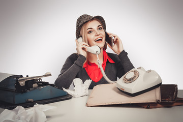 Beautiful retro business woman vintage secretary talking telephone on gray background