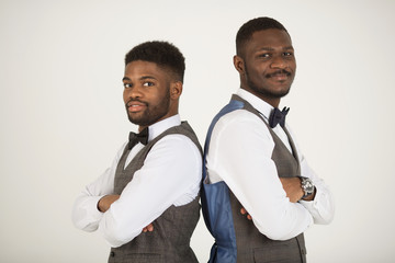 two stylish african men in suits on white background