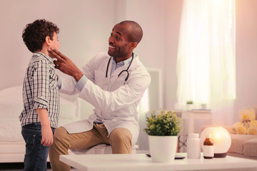 Otolaryngologist diagnosing tonsillitis at young patients home