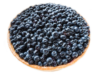 An entire of blueberry cheesecake with jam and fresh blueberries isolated on white background.