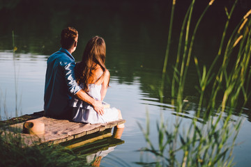 young love couple at the lake in summer sunset