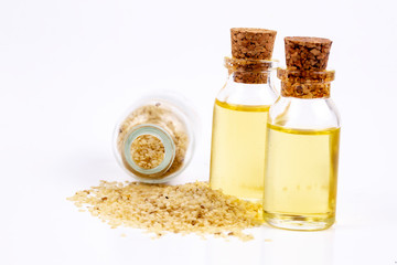 Sesame oil in glass and seeds isolated