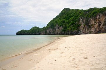 Paradise Thung San beach with white sand and rocky limestone cliff at Pathio District of Chumphon province of Thailand