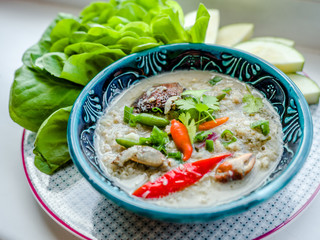 Salted crab stew with coconut milk, minced pork served with vegetables, Thai food.