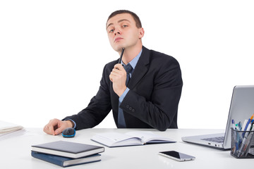  Serious businessman skeptically looking at you sitting at his desk isolated on white background.Human face expression