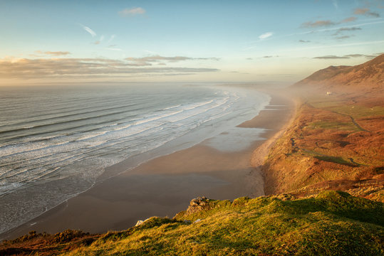 Landscape image of Rhossili Bay, South Wales at sunset