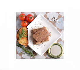 Pieces of tuna in olive oil on tile