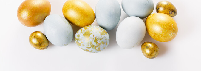 Easter background with Easter eggs and spring flowers. Top view with copy space